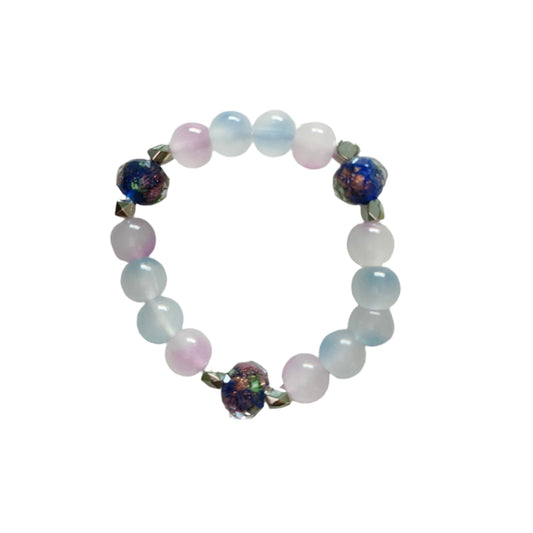 This midnight blue bracelet features beautiful rose gold sand lampwork beads, paired with vibrant 8mm blue and pink glass beads and silver spacer beads. The elastic design allows for a comfortable fit and easy on/off. Elevate any outfit and make a statement with this unique and stylish accessory!