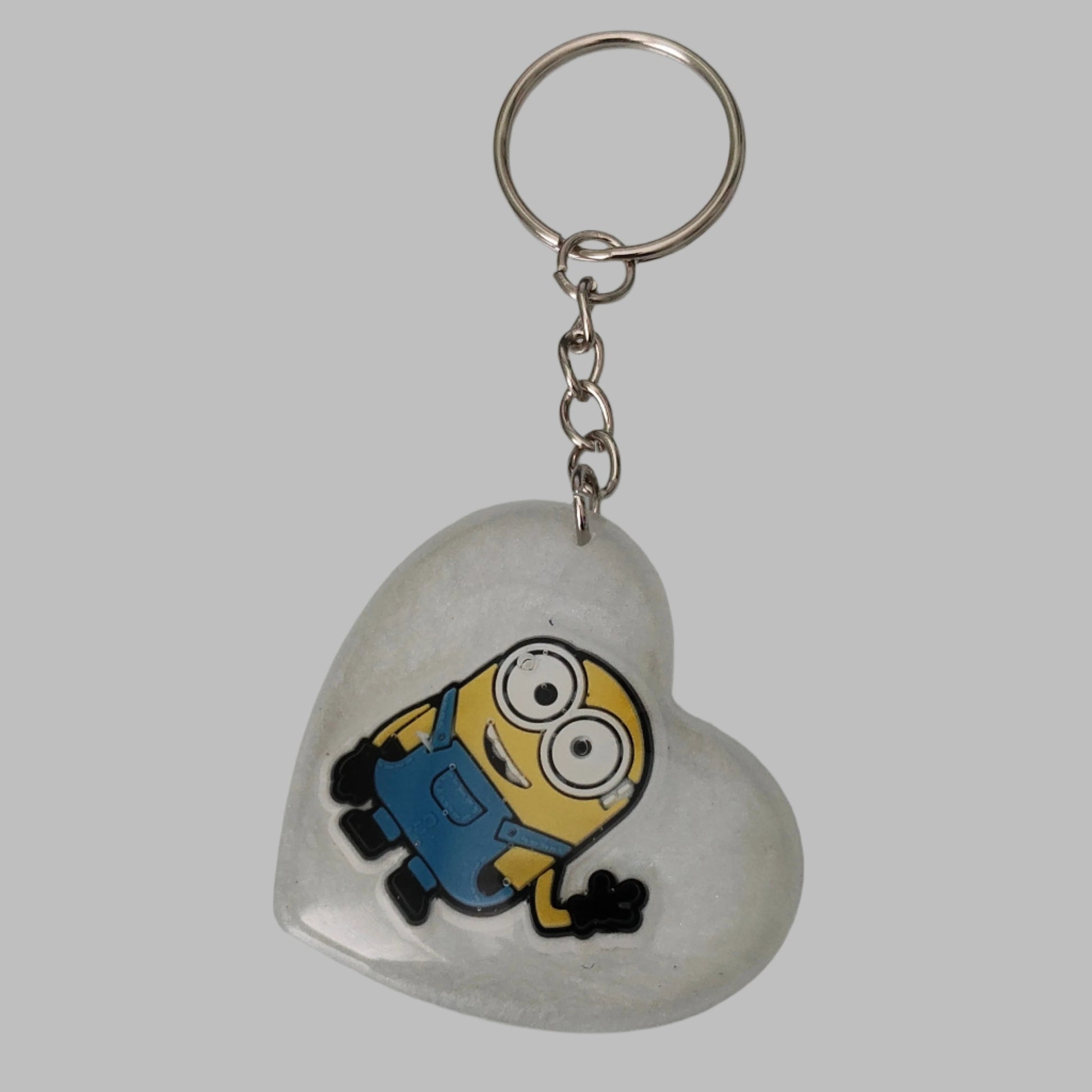Heartwarming and whimsical, our 3D resin minions heart keychain is perfect for any fan of the beloved characters. Durable and compact, it securely holds your keys while adding a touch of fun to your everyday carry. Makes a great gift for yourself or a loved one!
