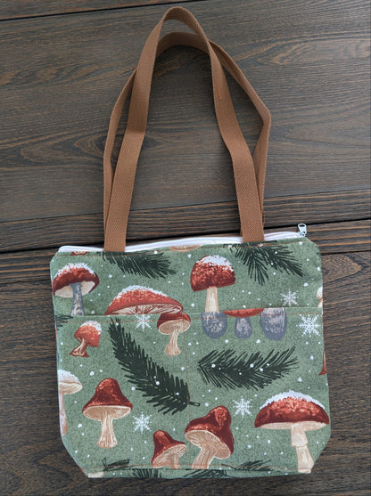 Crafted from durable cotton, this 13x9" bag features a sturdy 3.5" flat bottom and comfortable 26-inch straps for easy carrying. The vibrant orange lining adds a pop of color inside, while two outer pockets and one inner pocket keep your essentials organized. 