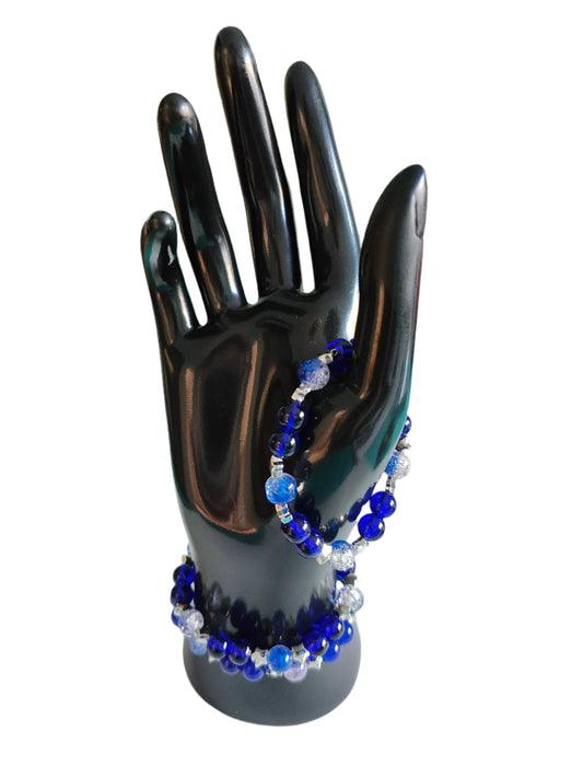 Elevate your style with our 8mm navy and blue crackle glass bead bracelet, adorned with silver spacer beads. The elastic band ensures a comfortable fit. Perfect for adding a touch of elegance to any outfit. Make a statement with this stunning accessory.