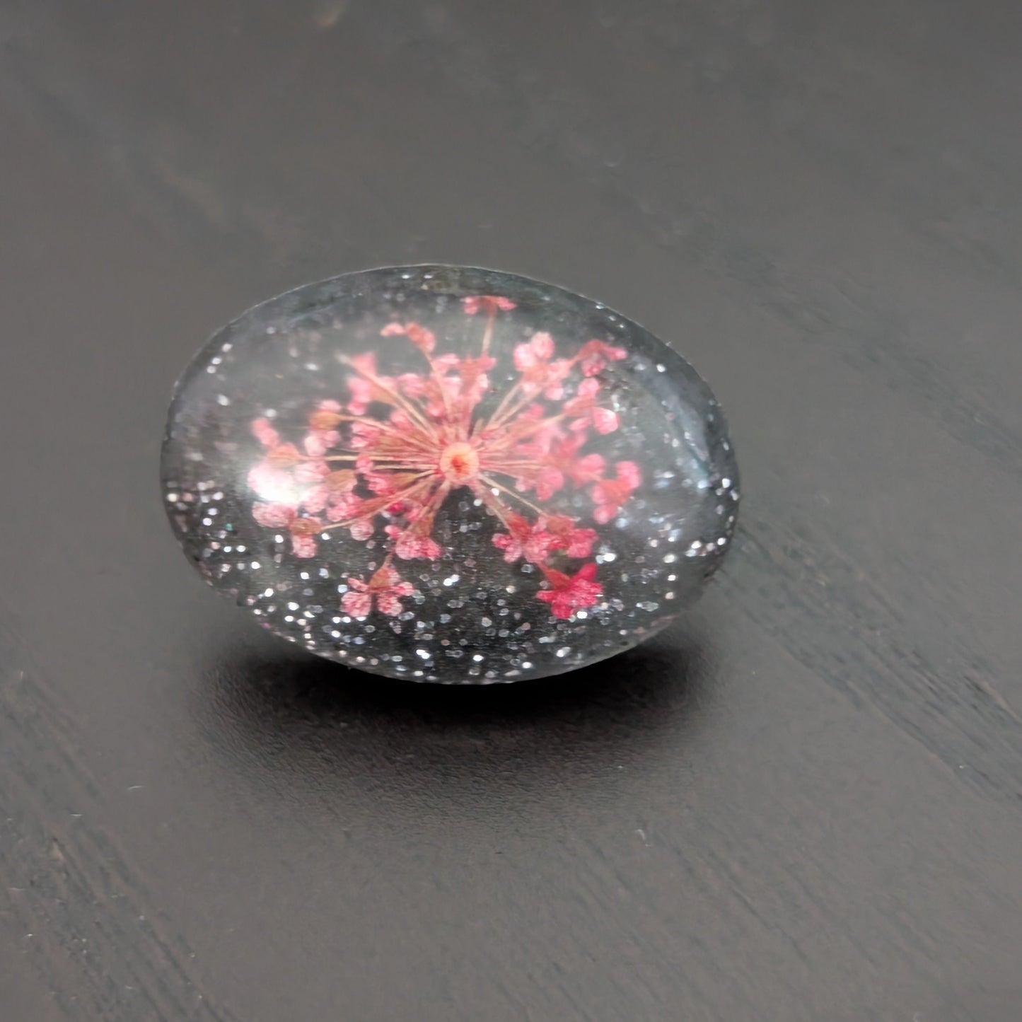 Add a touch of nature to your outfit with our Pin - 3D dried flower resin pin. The intricate design and 3D effect will surely catch everyone's eye. With the sturdy silver butterfly clutch, your pin will stay securely in place. Elevate your style with this unique and beautiful accessory.