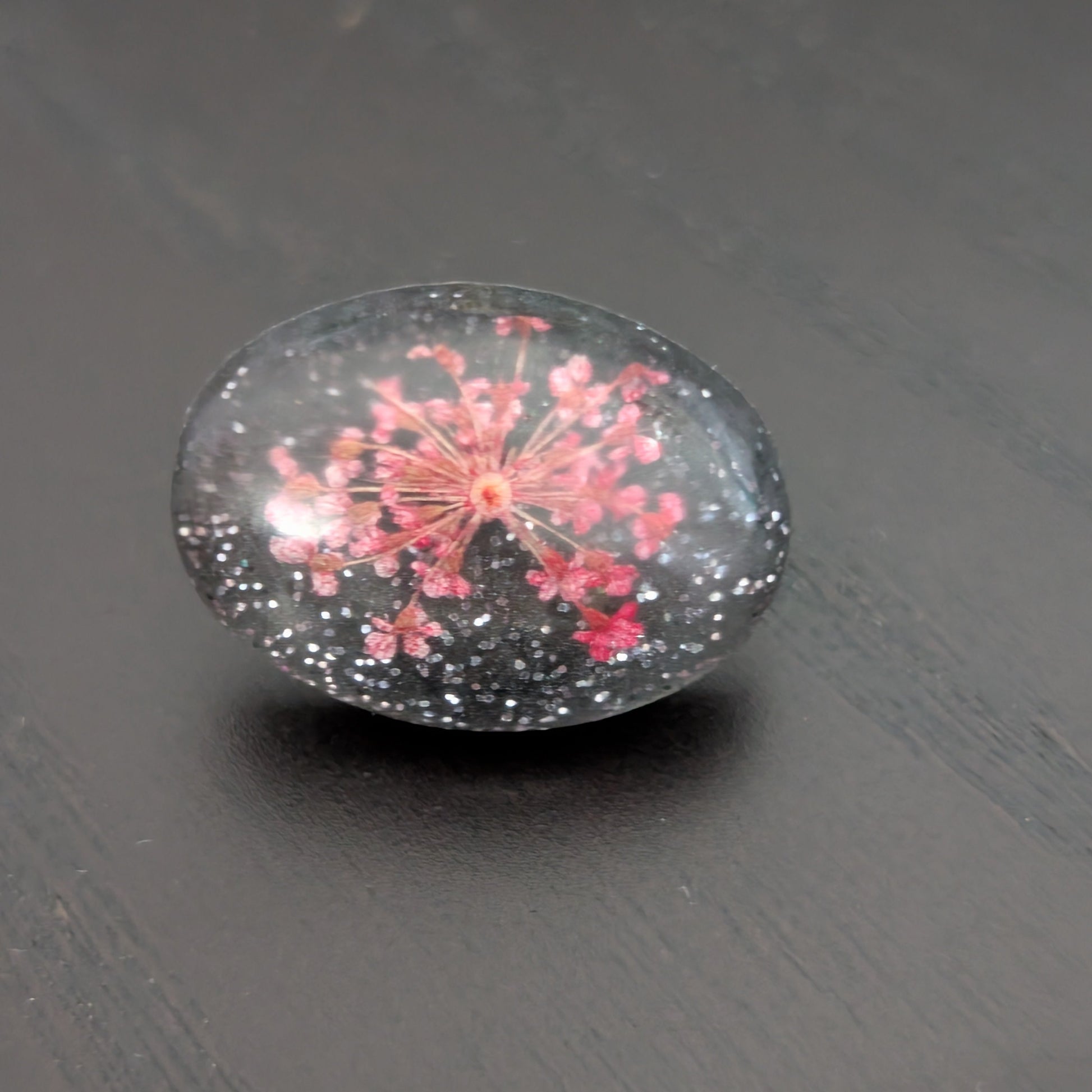 Add a touch of nature to your outfit with our Pin - 3D dried flower resin pin. The intricate design and 3D effect will surely catch everyone's eye. With the sturdy silver butterfly clutch, your pin will stay securely in place. Elevate your style with this unique and beautiful accessory.