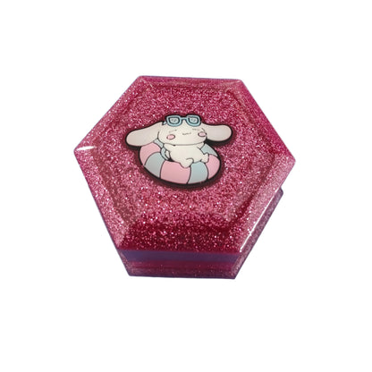 Add a touch of whimsy to your jewelry collection with our Knickknack Resin Hexagon Jewelry Box. The character lid adds a playful element to your storage, while the resin material ensures durability and protection for your precious pieces. Keep your jewelry safe and organized with this unique and charming box.