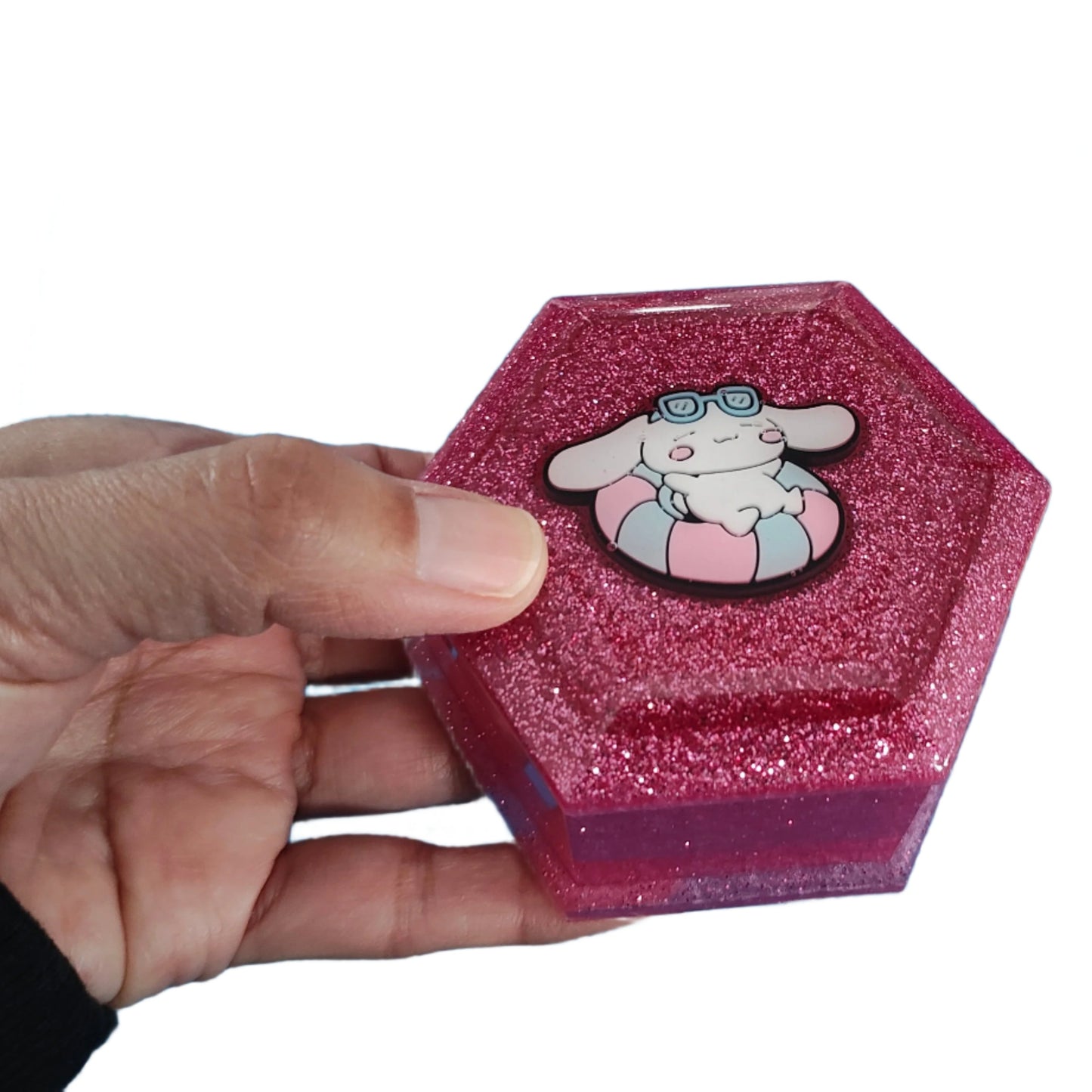 Add a touch of whimsy to your jewelry collection with our Knickknack Resin Hexagon Jewelry Box. The character lid adds a playful element to your storage, while the resin material ensures durability and protection for your precious pieces. Keep your jewelry safe and organized with this unique and charming box.