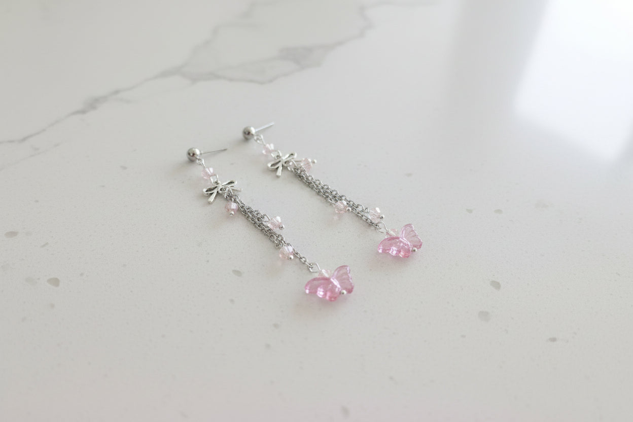 Elevate your everyday style with these enchanting butterfly earrings, featuring delicate silver chains, a charming bow accent, and sparkling crystal beads suspended from classic silver ball post studs. At approximately 3 inches in length, they offer the perfect balance of presence and wearability, making them ideal for both casual outings and special occasions. Weighing just 0.18 oz, these lightweight beauties won't weigh you down, allowing you to wear them comfortably all day long. The intricate design com