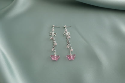Elevate your everyday style with these enchanting butterfly earrings, featuring delicate silver chains, a charming bow accent, and sparkling crystal beads suspended from classic silver ball post studs. At approximately 3 inches in length, they offer the perfect balance of presence and wearability, making them ideal for both casual outings and special occasions. Weighing just 0.18 oz, these lightweight beauties won't weigh you down, allowing you to wear them comfortably all day long. The intricate design com