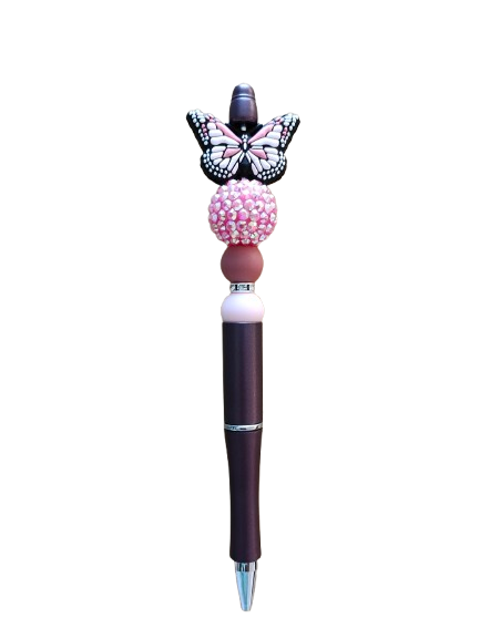 Unleash creativity with our Pen - Butterfly silicon beaded acrylic pen! Featuring sleek black ink, this pen is adorned with beautiful butterfly beads, perfect for adding a touch of whimsy to any writing task. Express yourself with every stroke!