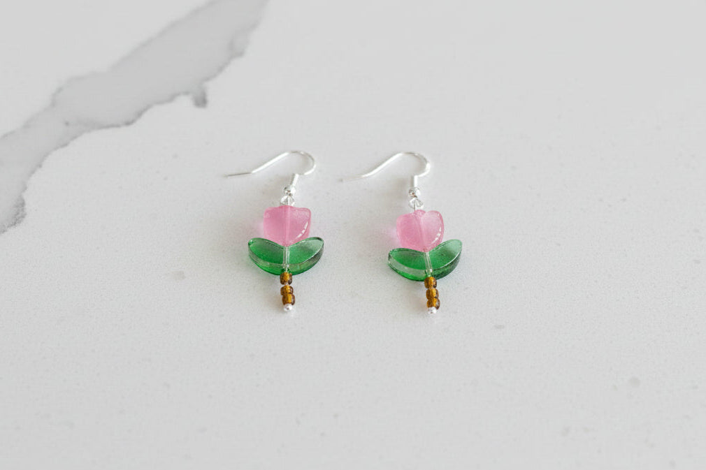 Delicate crystal and seed beads form an enchanting flower design, suspended from hypoallergenic 925 sterling silver hooks. These lightweight earrings measure just 1.5 inches, making them perfect for everyday elegance or layering with other pieces. At only 0.1 oz, they're comfortable enough to wear all day without fatigue. The shimmering bead work catches light beautifully, adding a touch of sparkle and sophistication to any outfit. Ideal for those who appreciate handcrafted jewelry with timeless appeal.