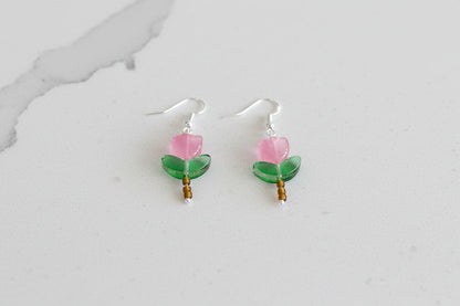 Delicate crystal and seed beads form an enchanting flower design, suspended from hypoallergenic 925 sterling silver hooks. These lightweight earrings measure just 1.5 inches, making them perfect for everyday elegance or layering with other pieces. At only 0.1 oz, they're comfortable enough to wear all day without fatigue. The shimmering bead work catches light beautifully, adding a touch of sparkle and sophistication to any outfit. Ideal for those who appreciate handcrafted jewelry with timeless appeal.