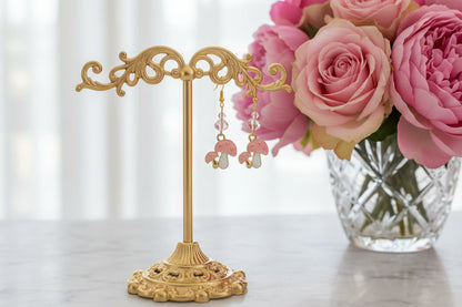 Enchanting mushroom earrings featuring delicate crystal beads nestled on lustrous gold plated hooks. Each earring measures approximately 2 inches, striking the perfect balance between statement-making and wearable elegance. At just 0.15 oz per pair, these lightweight beauties won't weigh you down, making them ideal for all-day wear. The shimmering gold plating catches the light beautifully, while the crystal accents add a touch of sparkle and sophistication. 