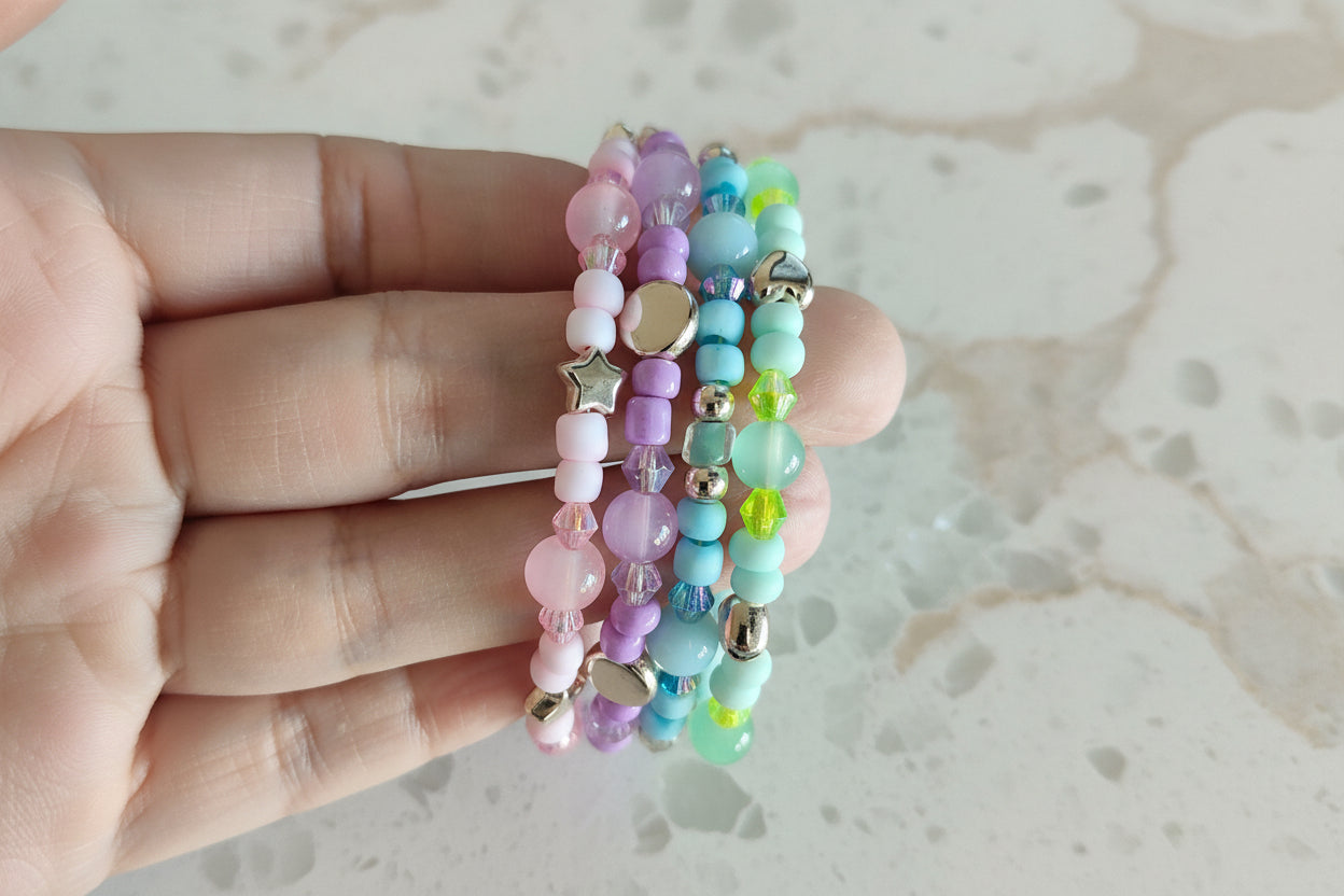 Embrace the beauty of the pastel tones with our 4 coil memory wire bracelet. With beads in shades of pink, purple, blue, and green, accented by rose gold spacer beads, this bracelet is a must-have for any jewelry lover. Feel confident and stylish with this unique and versatile accessory!
