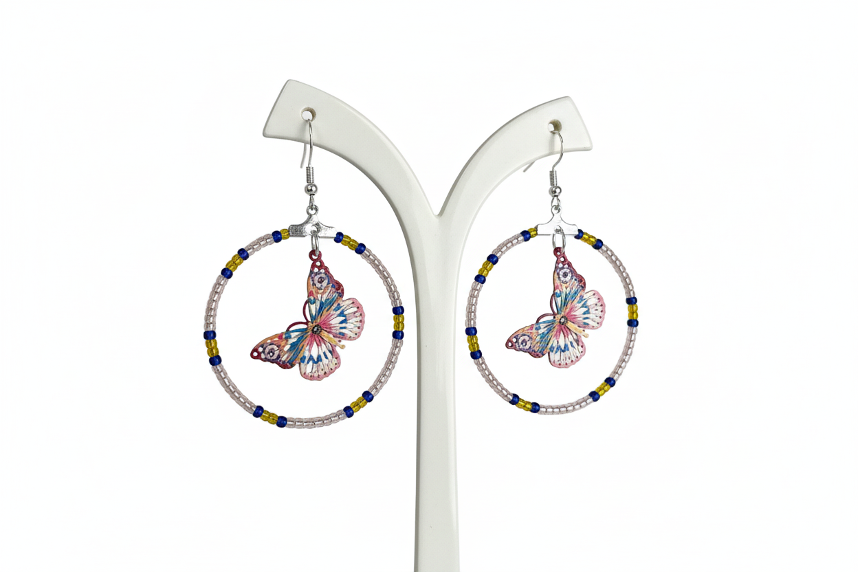 Add a touch of whimsy and elegance to your look with our Silver hoop earrings adorned with delicate seed beads and a beautiful filigree butterfly charm. These versatile earrings can take you from day to night, elevating any outfit with their unique design and stunning details. A must-have for any jewelry collection!