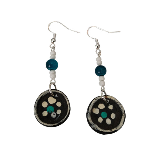 Add a touch of whimsy to your look with these playful earrings featuring ceramic plates adorned with crystal and seed beads. Suspended from silver hooks, these 2.5 inch long earrings are lightweight at just 0.12 oz. Make a statement with these unique earrings!