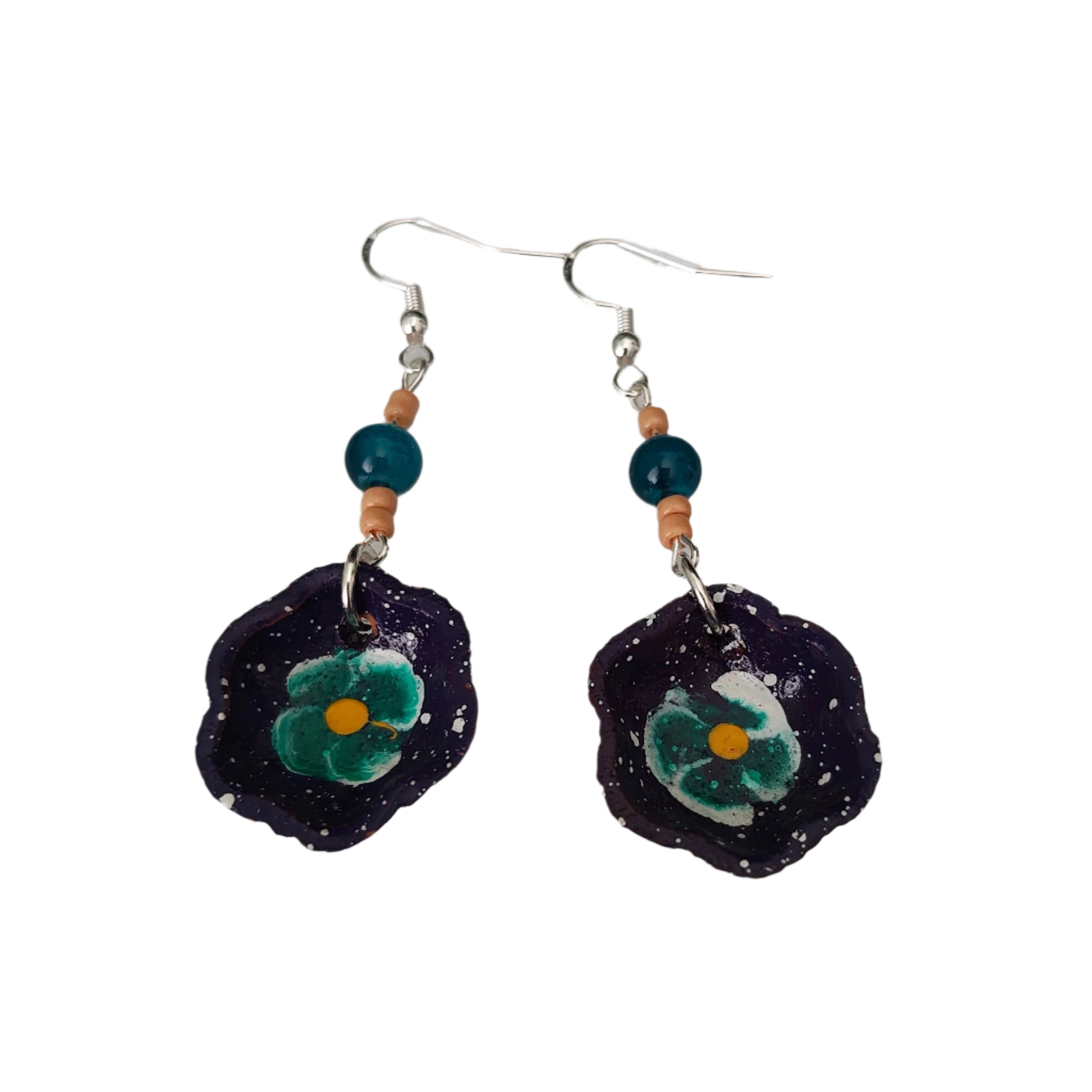 Add a taste of Mexico to your wardrobe with our Earrings! Unique ceramic plates adorned with crystal and seed beads dangle from sleek silver hooks. At 2.5 inches long and weighing only 0.13 oz, these earrings are a lightweight and stylish addition to any outfit.