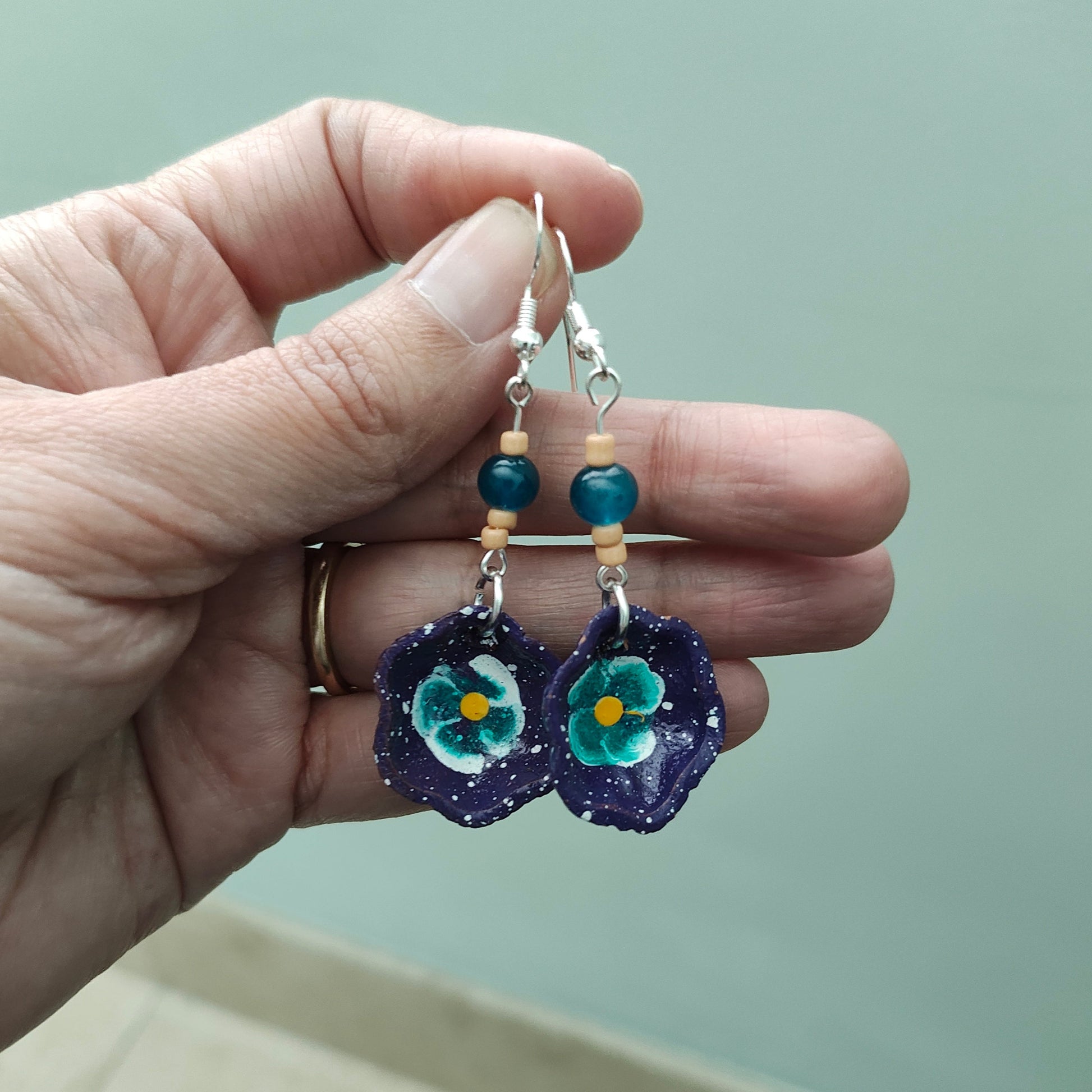 Add a taste of Mexico to your wardrobe with our Earrings! Unique ceramic plates adorned with crystal and seed beads dangle from sleek silver hooks. At 2.5 inches long and weighing only 0.13 oz, these earrings are a lightweight and stylish addition to any outfit.