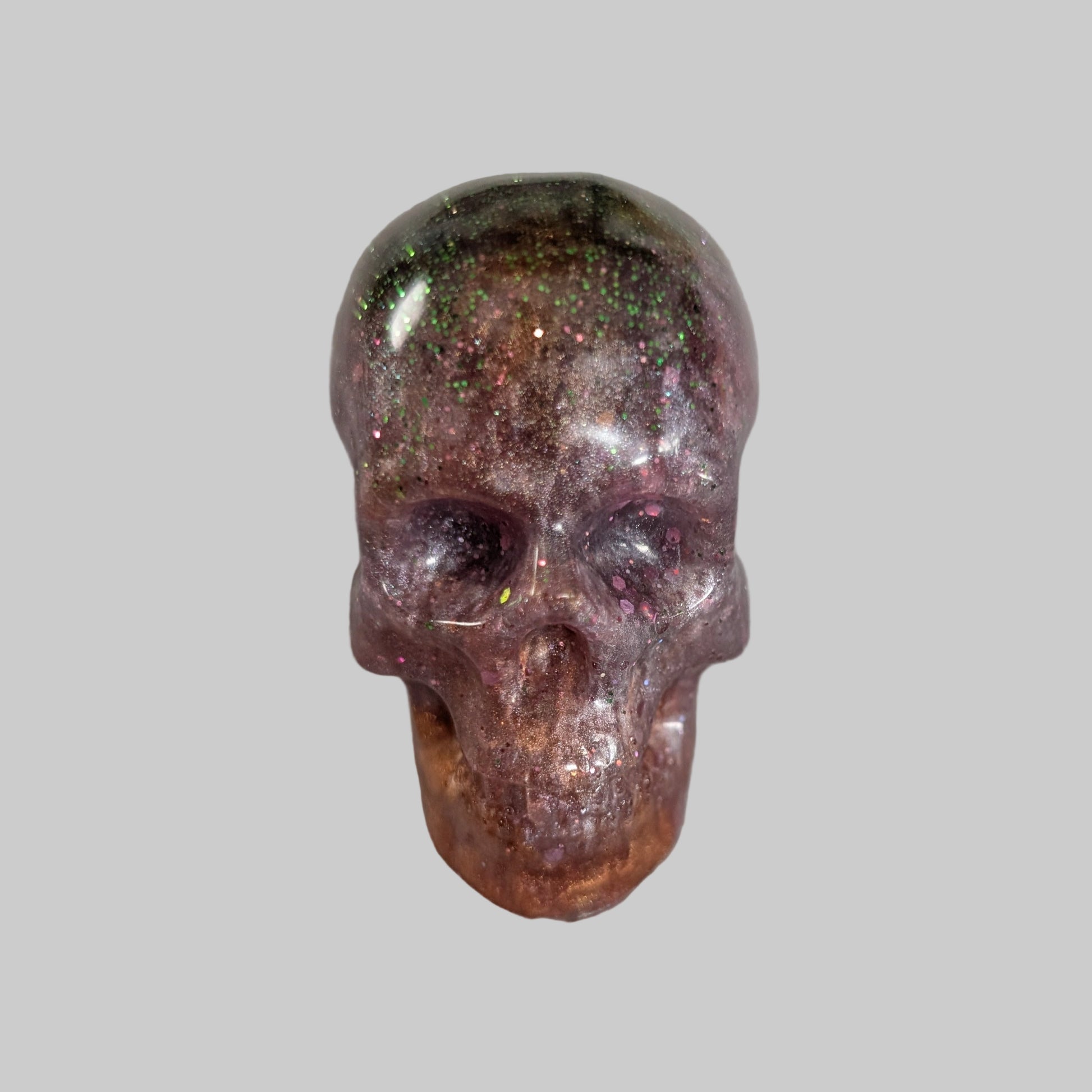 Add a unique touch to your home decor with our Knickknack - Resin small skull. Made with high-quality resin, this skull is a perfect blend of edginess and creativity. Elevate your space with this eye-catching piece that will surely spark your imagination.