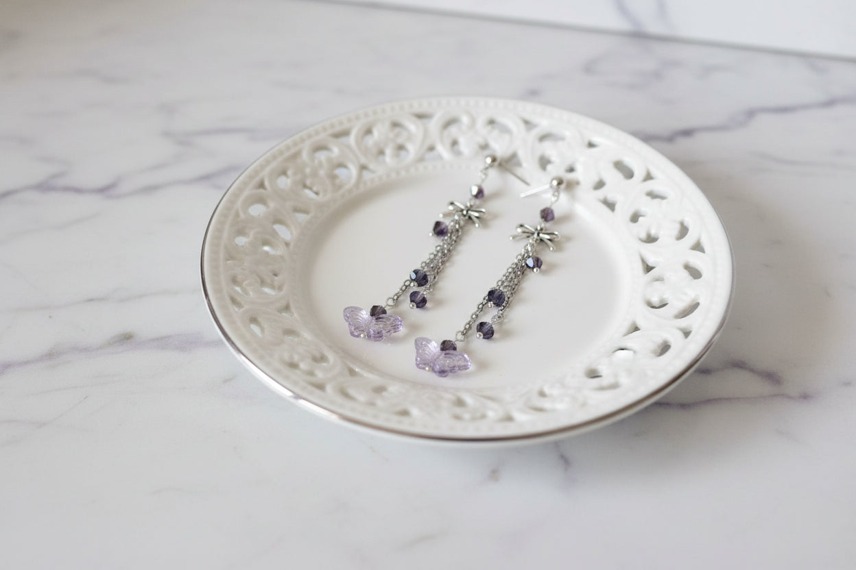 Elevate your everyday style with these enchanting butterfly earrings, featuring delicate silver chains, a charming bow accent, and sparkling crystal beads suspended from classic silver ball post studs. At approximately 3 inches in length, they offer the perfect balance of presence and wearability, making them ideal for both casual outings and special occasions. Weighing just 0.18 oz, these lightweight beauties won't weigh you down, allowing you to wear them comfortably all day long. The intricate design com