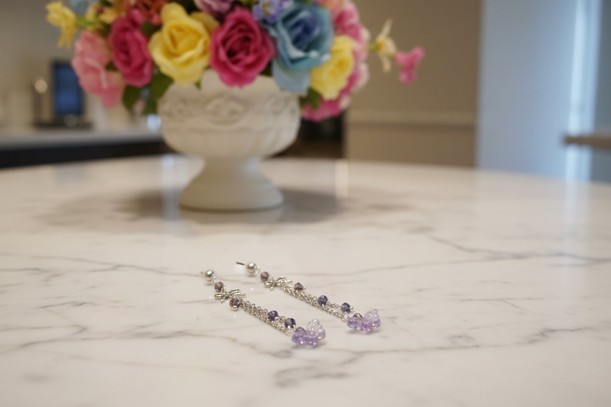 Elevate your everyday style with these enchanting butterfly earrings, featuring delicate silver chains, a charming bow accent, and sparkling crystal beads suspended from classic silver ball post studs. At approximately 3 inches in length, they offer the perfect balance of presence and wearability, making them ideal for both casual outings and special occasions. Weighing just 0.18 oz, these lightweight beauties won't weigh you down, allowing you to wear them comfortably all day long. The intricate design com