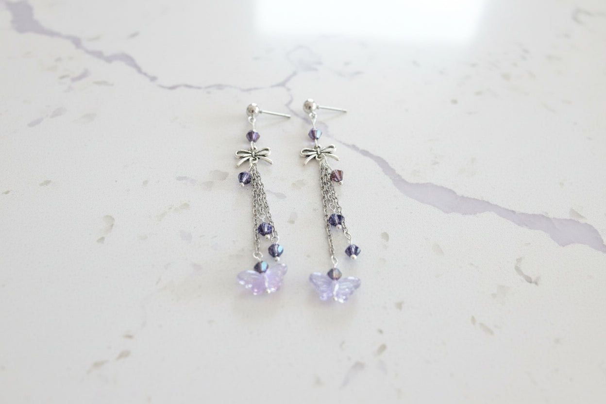 Elevate your everyday style with these enchanting butterfly earrings, featuring delicate silver chains, a charming bow accent, and sparkling crystal beads suspended from classic silver ball post studs. At approximately 3 inches in length, they offer the perfect balance of presence and wearability, making them ideal for both casual outings and special occasions. Weighing just 0.18 oz, these lightweight beauties won't weigh you down, allowing you to wear them comfortably all day long. The intricate design com