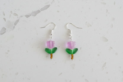 Delicate crystal and seed beads form an enchanting flower design, suspended from hypoallergenic 925 sterling silver hooks. These lightweight earrings measure just 1.5 inches, making them perfect for everyday elegance or layering with other pieces. At only 0.1 oz, they're comfortable enough to wear all day without fatigue. The shimmering bead work catches light beautifully, adding a touch of sparkle and sophistication to any outfit. Ideal for those who appreciate handcrafted jewelry with timeless appeal.