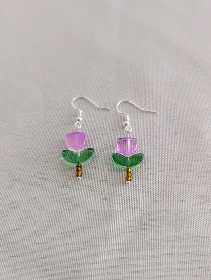 Delicate crystal and seed beads form an enchanting flower design, suspended from hypoallergenic 925 sterling silver hooks. These lightweight earrings measure just 1.5 inches, making them perfect for everyday elegance or layering with other pieces. At only 0.1 oz, they're comfortable enough to wear all day without fatigue. The shimmering bead work catches light beautifully, adding a touch of sparkle and sophistication to any outfit. Ideal for those who appreciate handcrafted jewelry with timeless appeal.