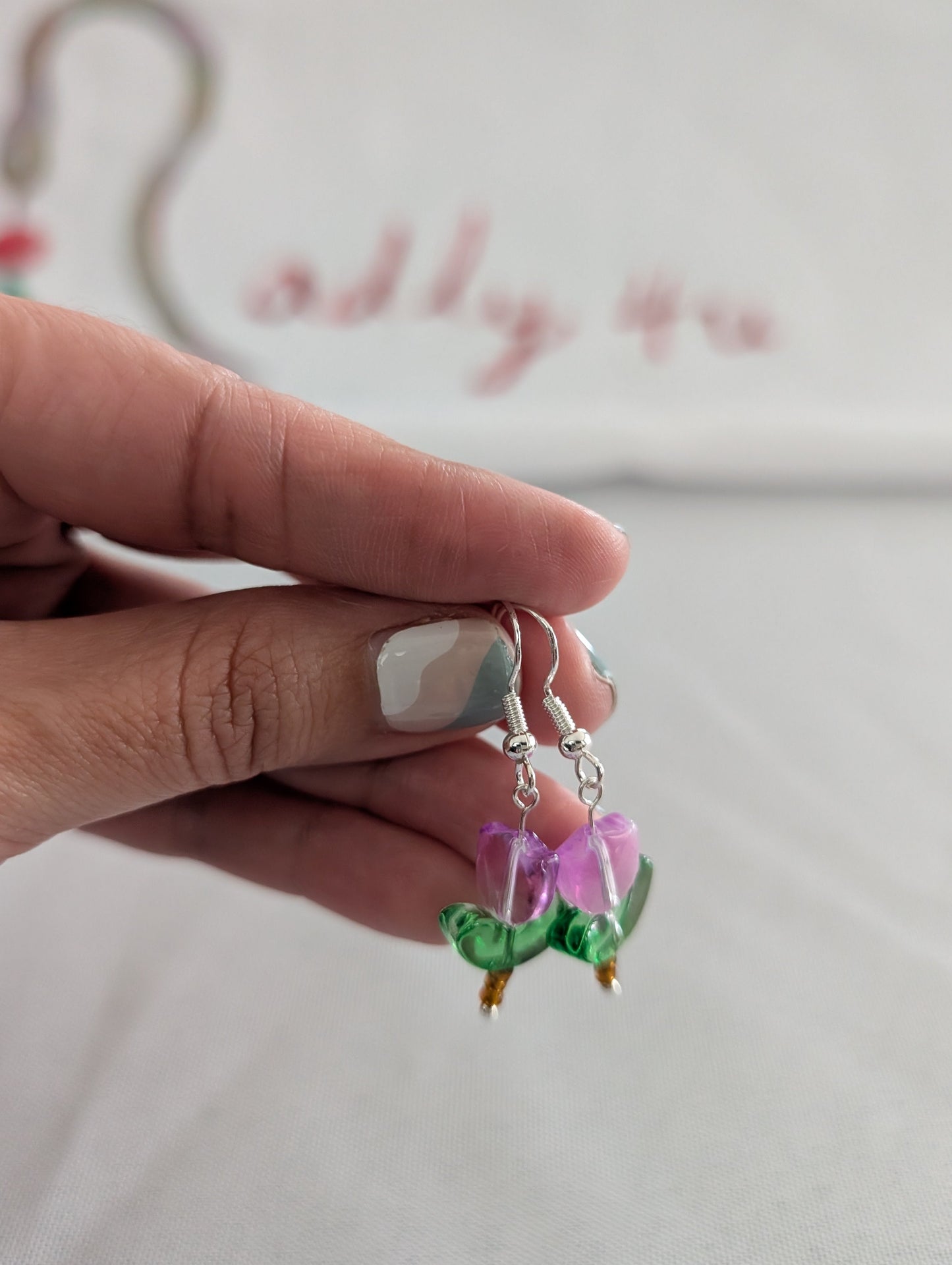 Delicate crystal and seed beads form an enchanting flower design, suspended from hypoallergenic 925 sterling silver hooks. These lightweight earrings measure just 1.5 inches, making them perfect for everyday elegance or layering with other pieces. At only 0.1 oz, they're comfortable enough to wear all day without fatigue. The shimmering bead work catches light beautifully, adding a touch of sparkle and sophistication to any outfit. Ideal for those who appreciate handcrafted jewelry with timeless appeal.