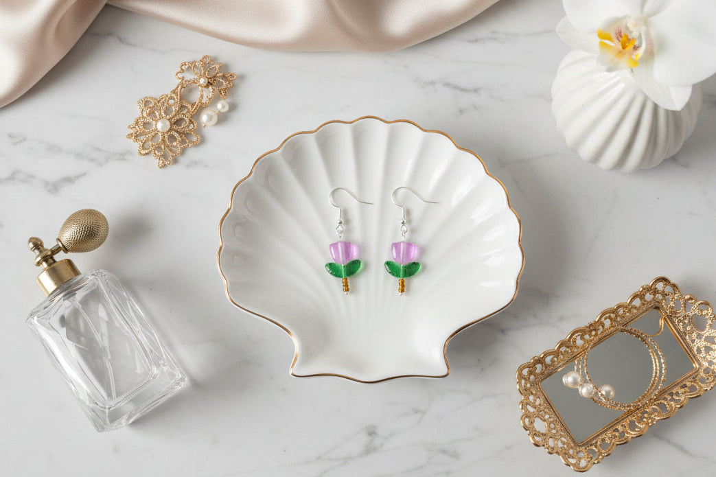 Delicate crystal and seed beads form an enchanting flower design, suspended from hypoallergenic 925 sterling silver hooks. These lightweight earrings measure just 1.5 inches, making them perfect for everyday elegance or layering with other pieces. At only 0.1 oz, they're comfortable enough to wear all day without fatigue. The shimmering bead work catches light beautifully, adding a touch of sparkle and sophistication to any outfit. Ideal for those who appreciate handcrafted jewelry with timeless appeal.