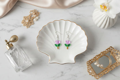 Delicate crystal and seed beads form an enchanting flower design, suspended from hypoallergenic 925 sterling silver hooks. These lightweight earrings measure just 1.5 inches, making them perfect for everyday elegance or layering with other pieces. At only 0.1 oz, they're comfortable enough to wear all day without fatigue. The shimmering bead work catches light beautifully, adding a touch of sparkle and sophistication to any outfit. Ideal for those who appreciate handcrafted jewelry with timeless appeal.