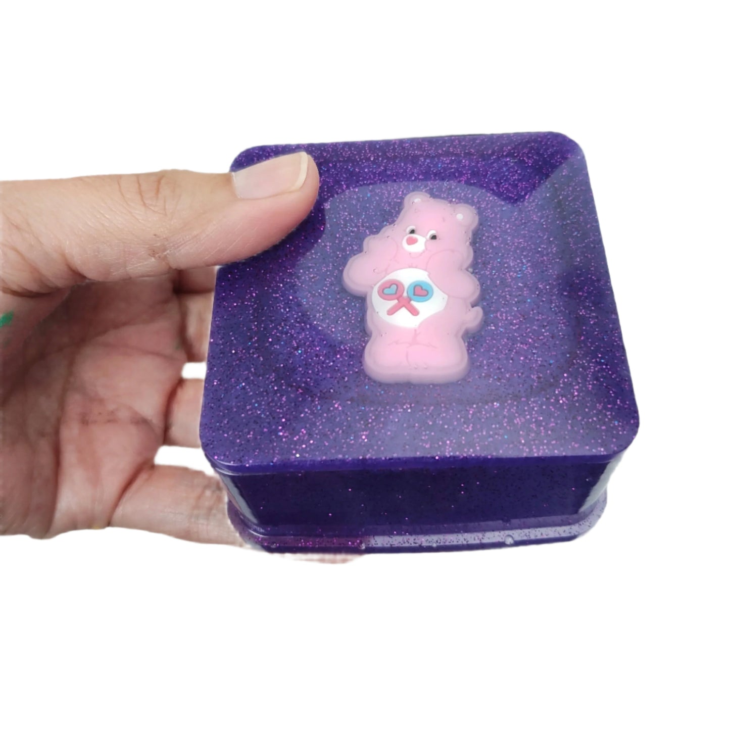 Elevate your jewelry storage game with our Knickknack resin square box. The character lid adds personality to this functional piece, keeping your treasures organized and protected. Made with high-quality resin, it's durable and long-lasting. Add a touch of charm to your vanity or dresser.