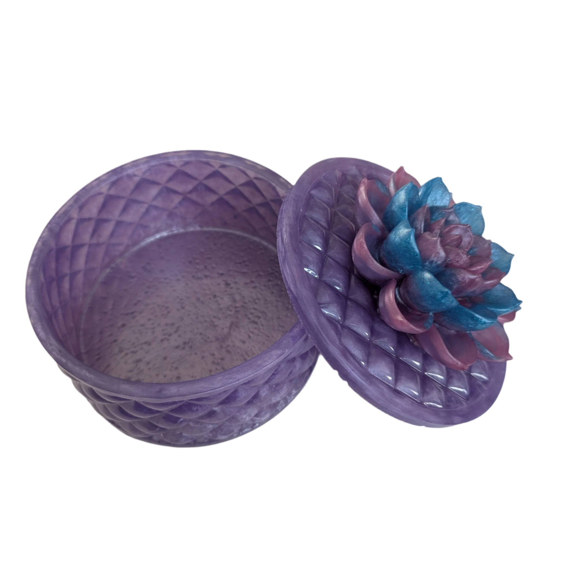 Keep your tiniest treasures safe in our round trinket box. With a charming resin design and a beautiful flower lid, it adds a playful touch to any space. At approximately 5 x 5 in, 4.25 in height, and weighing 11.7 oz, it's perfect for your precious items.