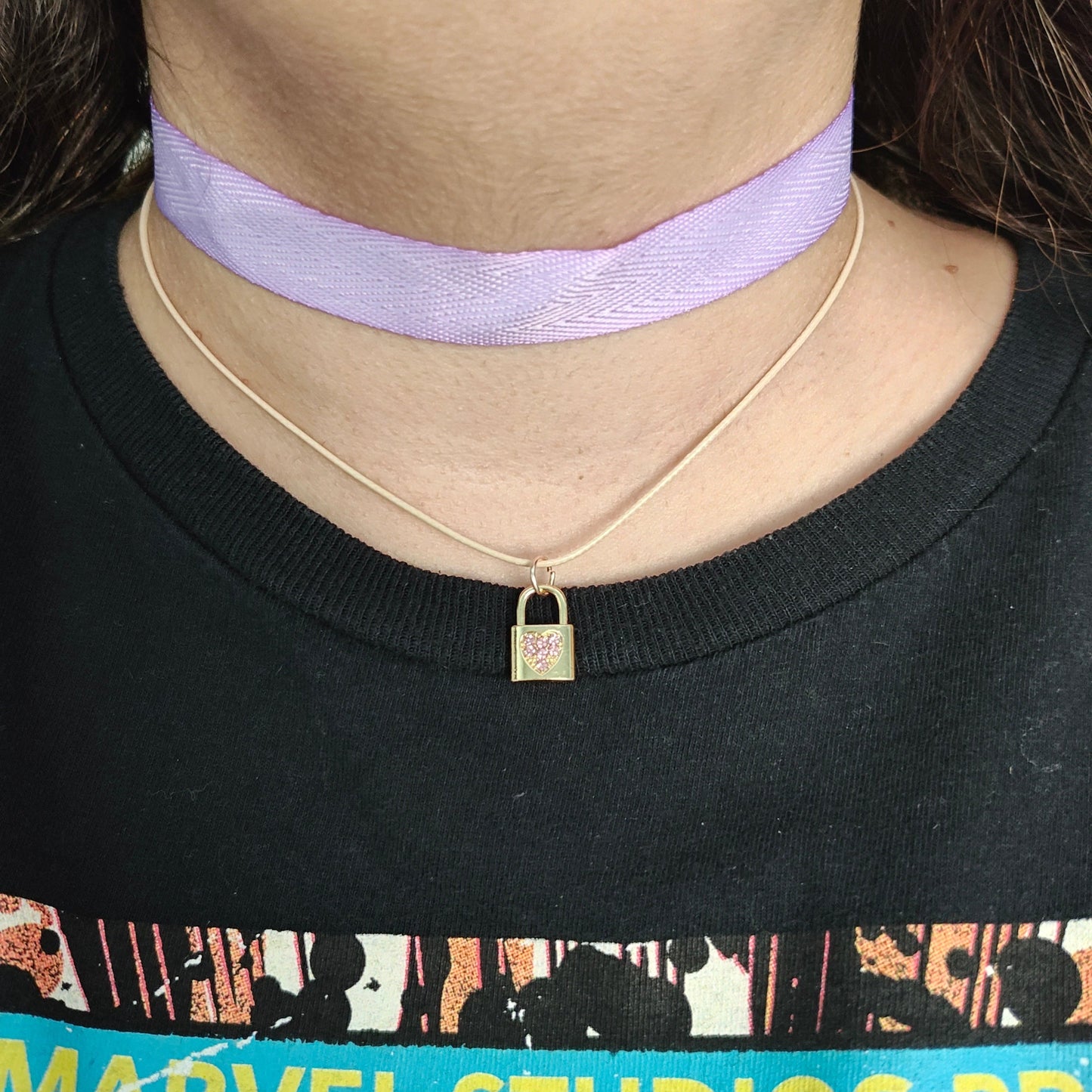 Elevate your style with our exquisite Necklace - Choker purple ribbon! Featuring a luxurious polyester strand and a dazzling gold charm with rhinestone lock, this statement piece is sure to turn heads. Add a touch of elegance and sophistication to any outfit with this stunning necklace.