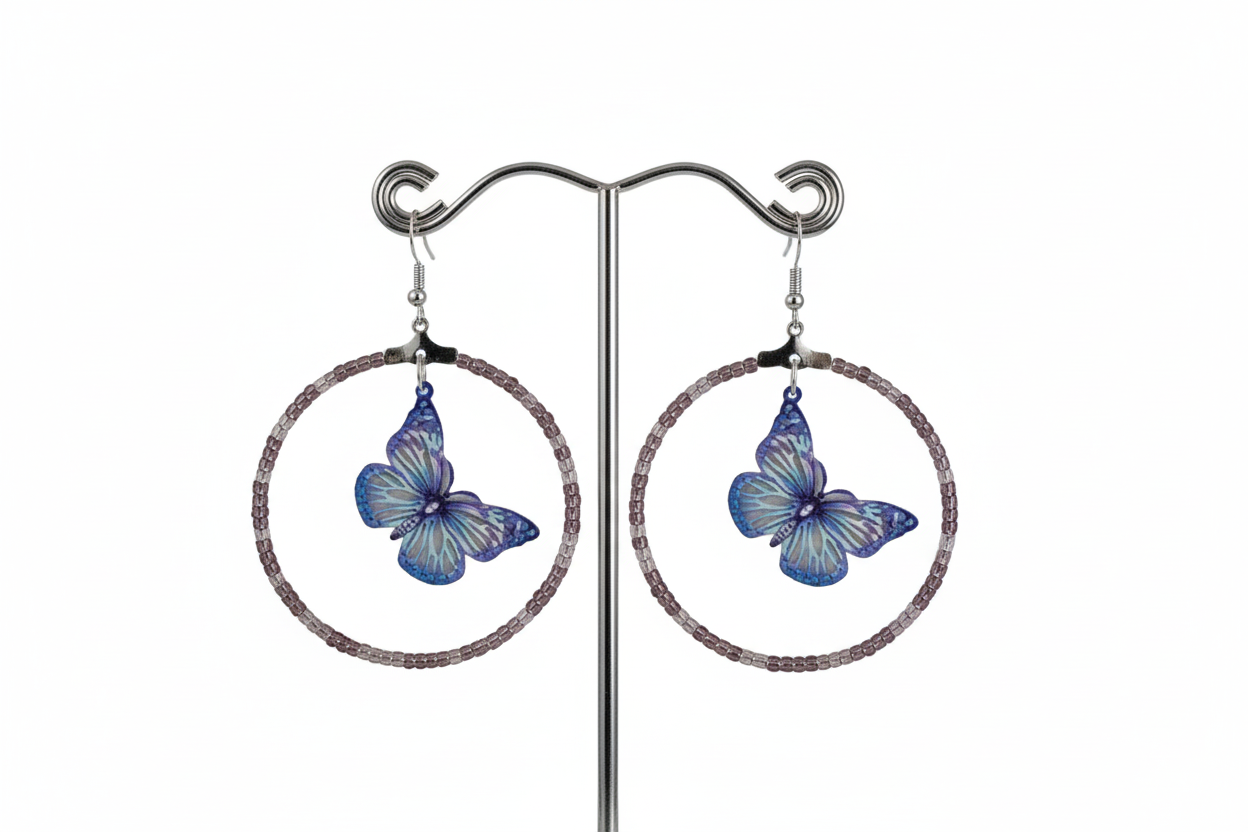 Add a touch of whimsy and elegance to your look with our Silver hoop earrings adorned with delicate seed beads and a beautiful filigree butterfly charm. These versatile earrings can take you from day to night, elevating any outfit with their unique design and stunning details. A must-have for any jewelry collection!