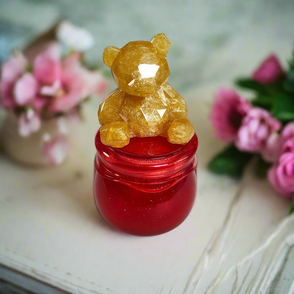 Add a touch of whimsy to your home with our Knickknack - Resin Jar. Featuring a playful bear screw on lid, this jar is perfect for storing small items. Measuring 2.75 x 2.75 inches with a height of 5 inches and a weight of 7.8 oz, it's both functional and fun!

Resin Jar with bear screw on lid