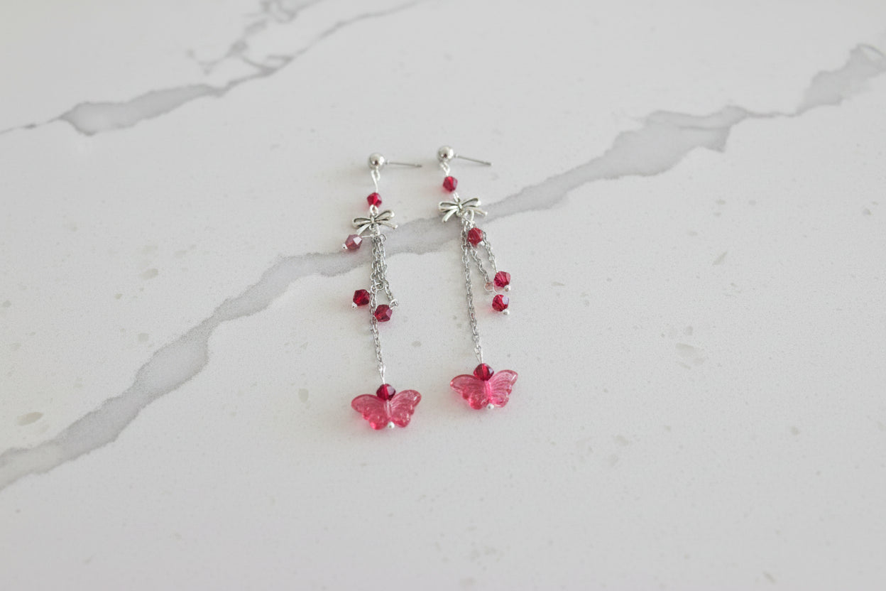 Elevate your everyday style with these enchanting butterfly earrings, featuring delicate silver chains, a charming bow accent, and sparkling crystal beads suspended from classic silver ball post studs. At approximately 3 inches in length, they offer the perfect balance of presence and wearability, making them ideal for both casual outings and special occasions. Weighing just 0.18 oz, these lightweight beauties won't weigh you down, allowing you to wear them comfortably all day long. The intricate design com