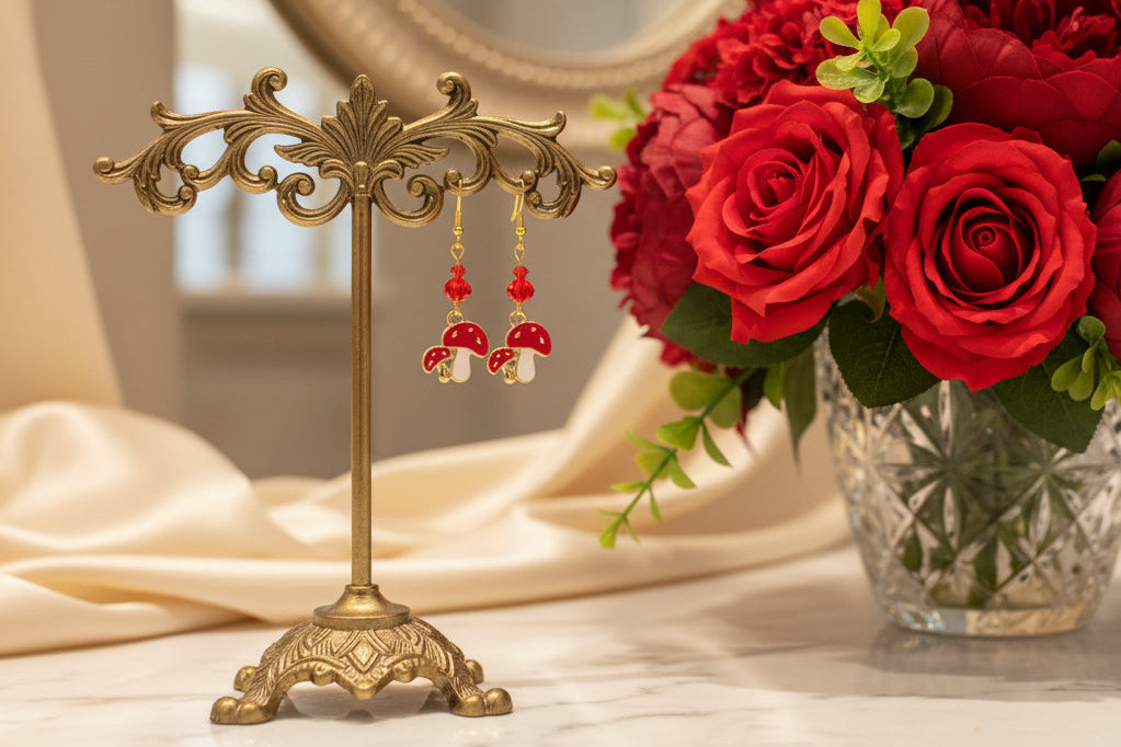 Enchanting mushroom earrings featuring delicate crystal beads nestled on lustrous gold plated hooks. Each earring measures approximately 2 inches, striking the perfect balance between statement-making and wearable elegance. At just 0.15 oz per pair, these lightweight beauties won't weigh you down, making them ideal for all-day wear. The shimmering gold plating catches the light beautifully, while the crystal accents add a touch of sparkle and sophistication. 