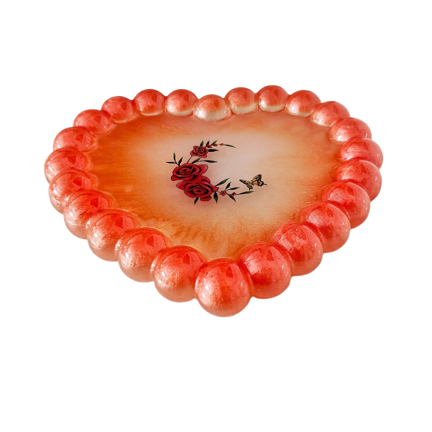 Elevate your space with our Resin Heart Trinket Tray. Formed into a heart shape, this tray is perfect for holding and displaying your small trinkets and treasures. Made of durable resin, it adds a touch of charm to any room while keeping your items organized and easily accessible.