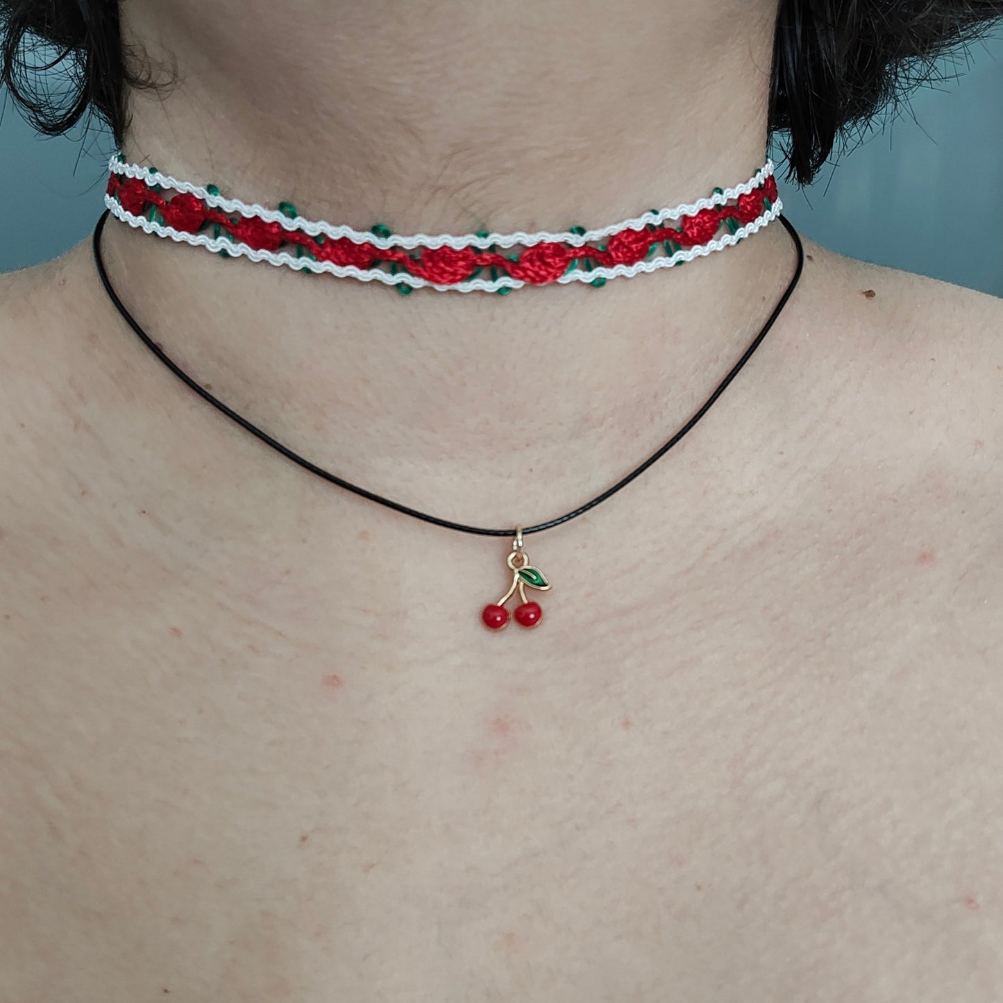 Add a sweet touch to your outfit with our red rose lace choker necklace. Made with a single polyester strand and a cherry charm, this playful piece will have you feeling fun and flirty. Perfect for any occasion, this necklace is sure to make a statement!