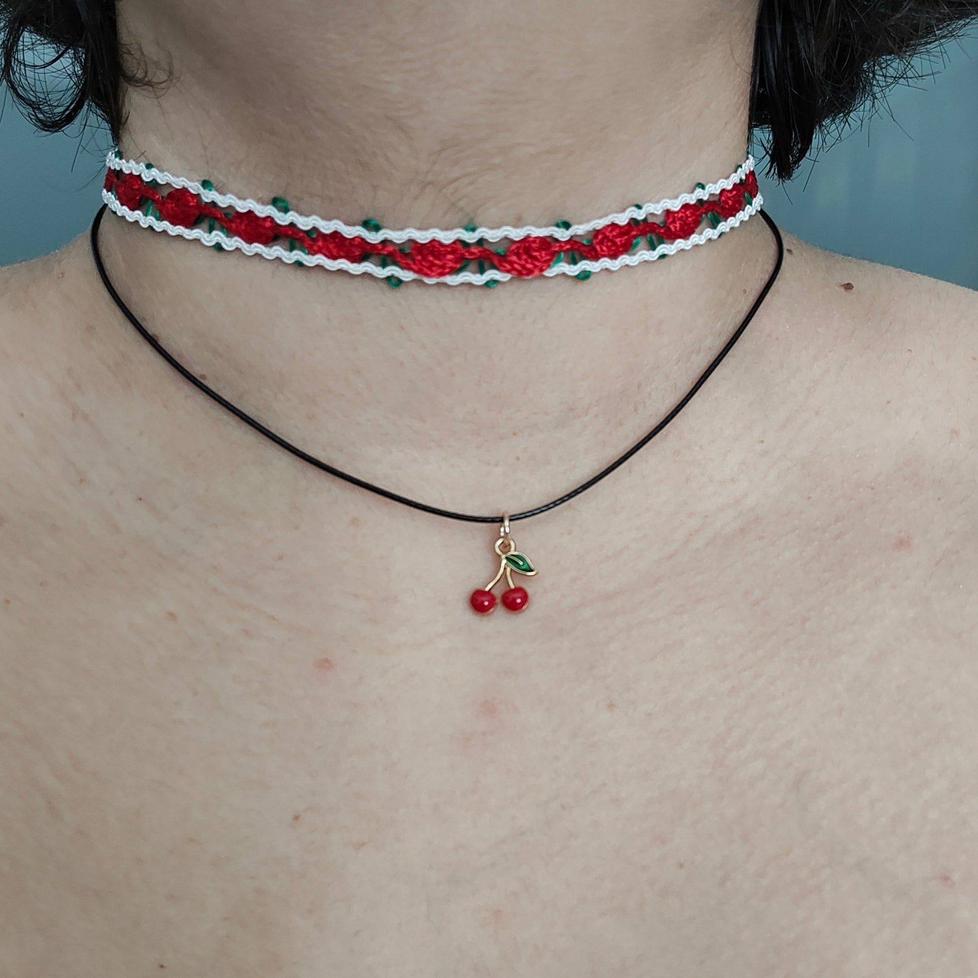 Add a sweet touch to your outfit with our red rose lace choker necklace. Made with a single polyester strand and a cherry charm, this playful piece will have you feeling fun and flirty. Perfect for any occasion, this necklace is sure to make a statement!
