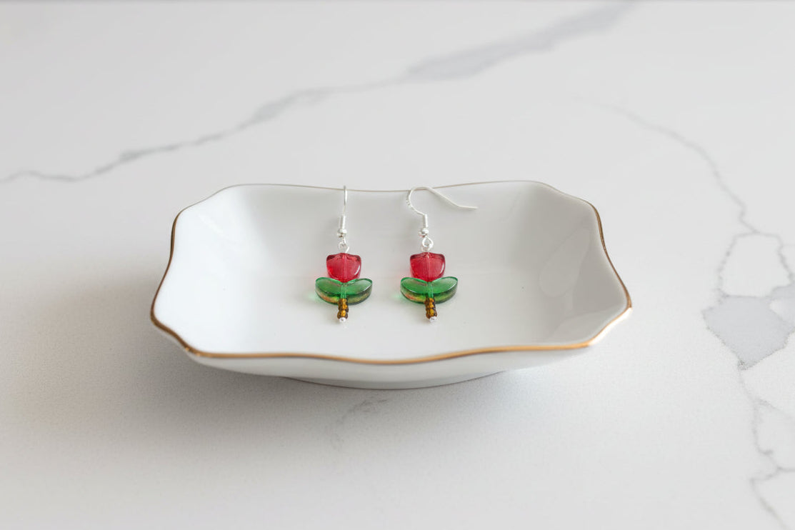 Delicate crystal and seed beads form an enchanting tulip design, suspended from hypoallergenic 925 sterling silver hooks. These lightweight earrings measure just 1.5 inches, making them perfect for everyday elegance or layering with other pieces. At only 0.1 oz, they're comfortable enough to wear all day without fatigue. The shimmering bead work catches light beautifully, adding a touch of sparkle and sophistication to any outfit. Ideal for those who appreciate handcrafted jewelry with timeless appeal.