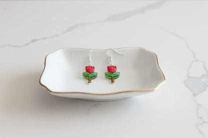 Delicate crystal and seed beads form an enchanting tulip design, suspended from hypoallergenic 925 sterling silver hooks. These lightweight earrings measure just 1.5 inches, making them perfect for everyday elegance or layering with other pieces. At only 0.1 oz, they're comfortable enough to wear all day without fatigue. The shimmering bead work catches light beautifully, adding a touch of sparkle and sophistication to any outfit. Ideal for those who appreciate handcrafted jewelry with timeless appeal.