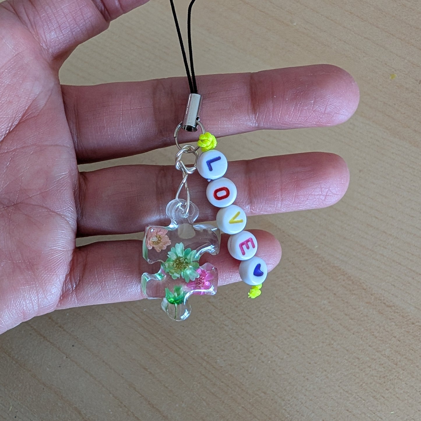 Spice up your phone with this charming resin charm, adorned with real dried flowers and beads. The 3.75 inch length adds a touch of flair to any device. (It's like a bouquet, but for your phone!)

Phone charm - Resin charm with dried flowers and beads
