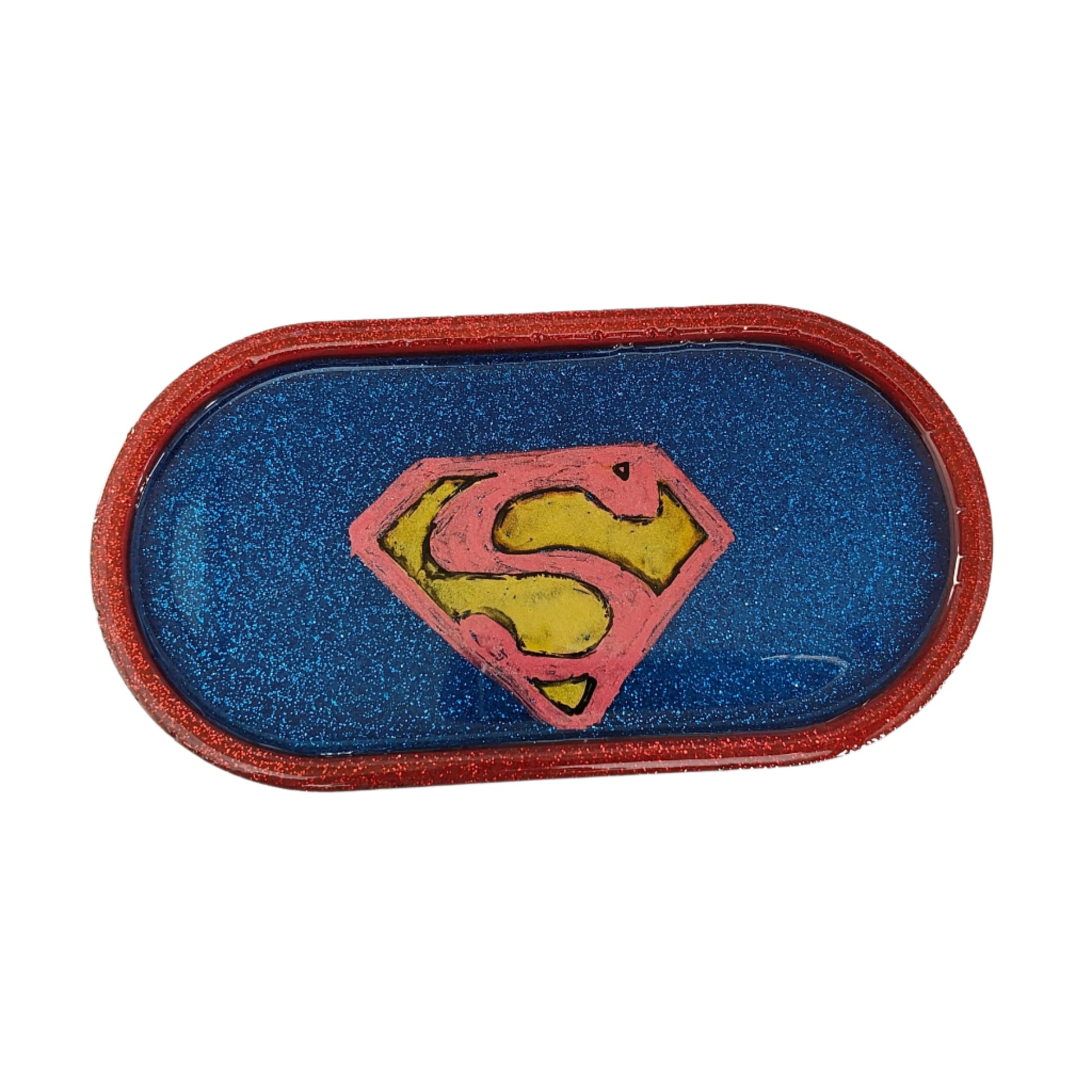 This Knickknack trinket dish not only adds a fun touch to any space with its super hero theme, but also serves as a functional and stylish storage option for small items. Made of durable resin, it is designed to keep jewelry, change, and other trinkets organized and easily accessible.