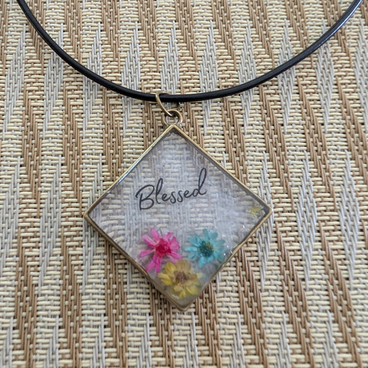 Elevate any outfit with our stunning 18 inches resin and flowers bronze diamond pendant necklace. The intricate Blessed design adds a touch of elegance, while the black 2mm leather cord provides a bold contrast. Lightweight and versatile, perfect for any occasion.