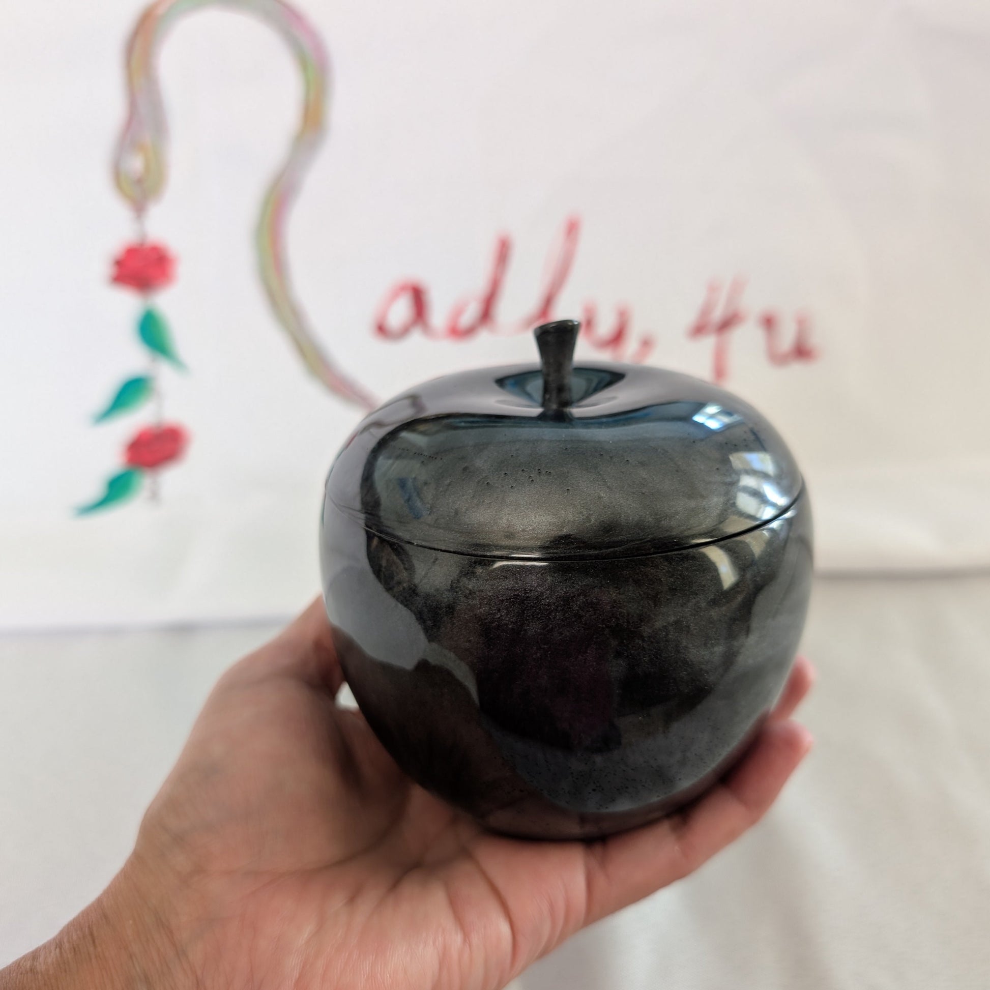 hand crafted with epoxy resin..

Epoxy resin is typically smooth, rigid, and non-porous, similar to a hard plastic or glass.

Knickknack - Resin apple trinket with lid