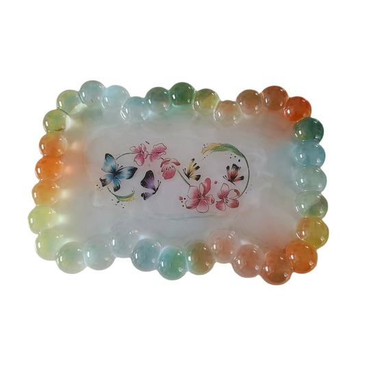 Elevate your trinket game with our Resin bow shape jewelry/trinket tray! Made of high-quality resin, this tray is as durable as it is stylish. Perfect for holding jewelry, keys, or other small items, it's a must-have addition to any dressing table or bedside. Get yours today and add a touch of elegance to your space!