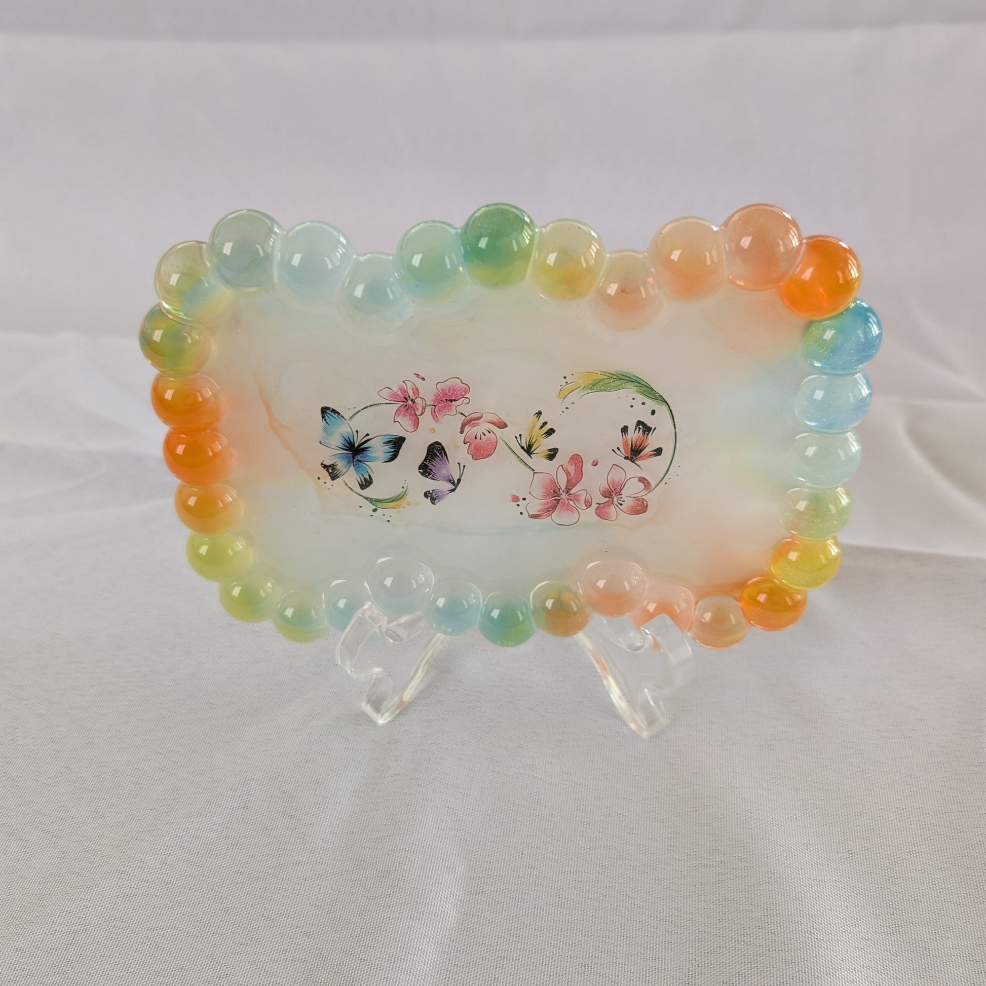 Elevate your trinket game with our Resin bow shape jewelry/trinket tray! Made of high-quality resin, this tray is as durable as it is stylish. Perfect for holding jewelry, keys, or other small items, it's a must-have addition to any dressing table or bedside. Get yours today and add a touch of elegance to your space!