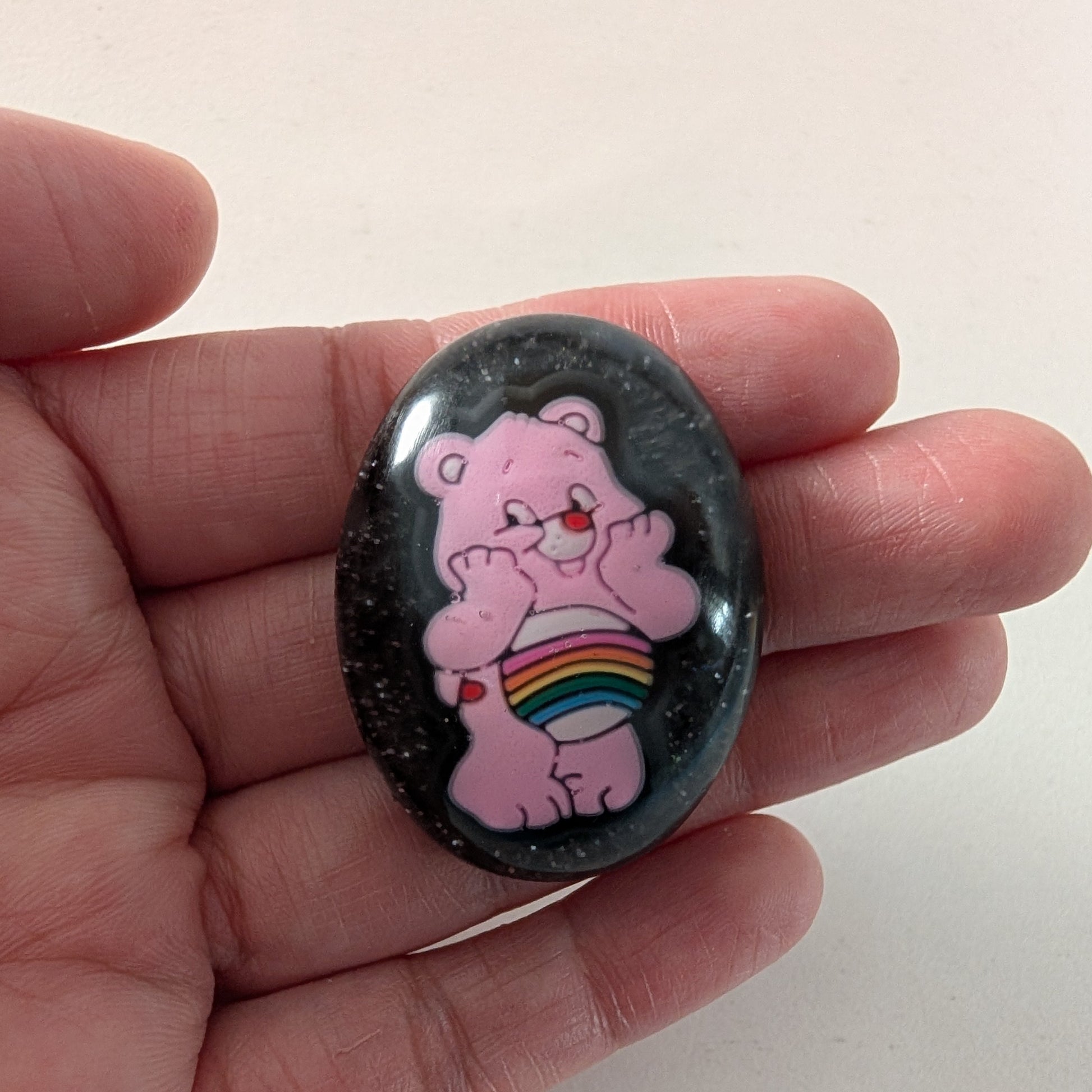 This 3D Care Bears resin pin adds a playful and nostalgic touch to any outfit or accessory. Crafted with detailed resin and secured by a silver butterfly clutch, it ensures both style and durability. Perfect for collectors or fans looking to brighten their day with a charming, wearable keepsake.