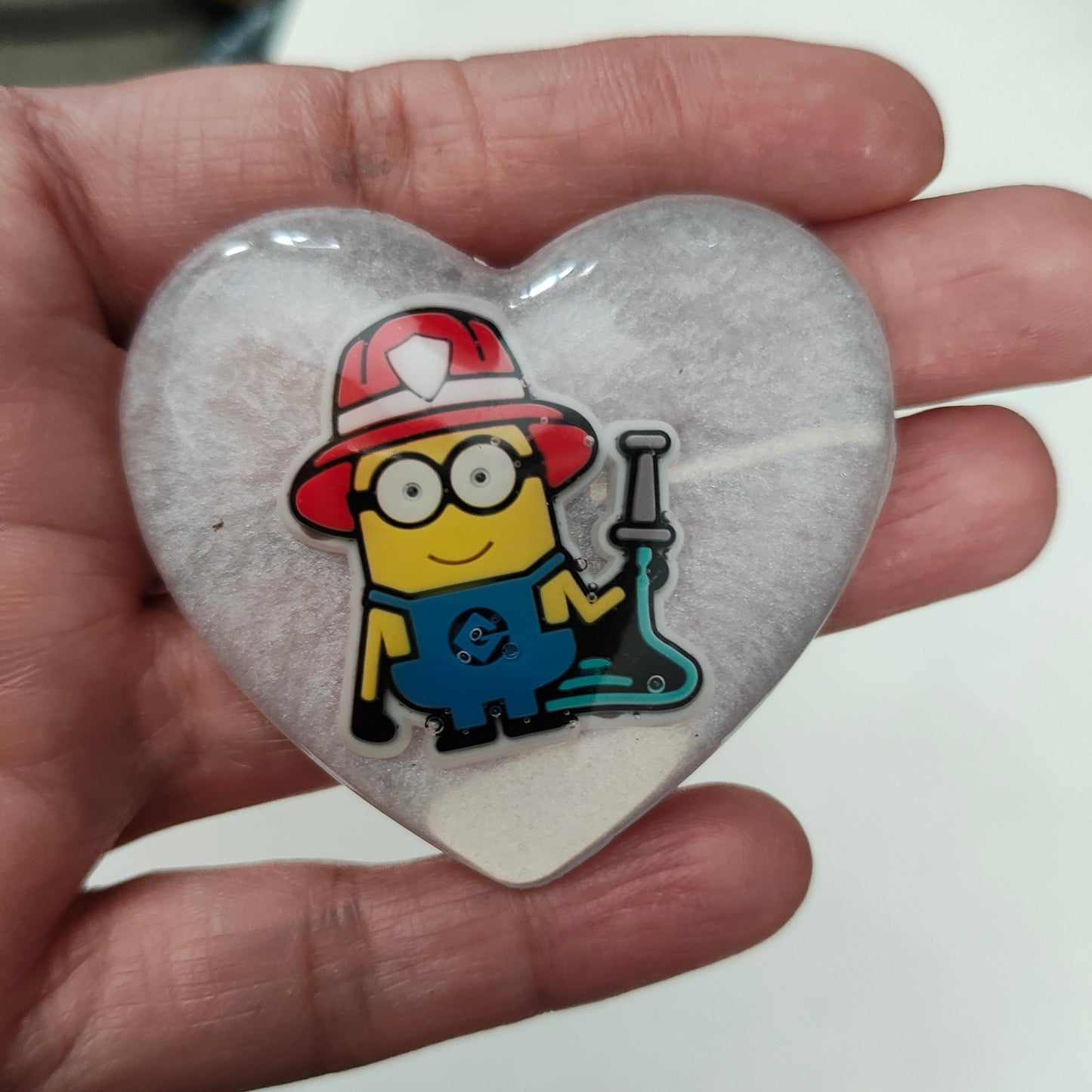 Get ready to add a touch of mischief to your outfit with our 3D minions resin pin! This playful pin features a silver butterfly clutch for easy application and measures 1.75 x 2 inches. Weighing only 0.40 oz, it's the perfect accessory for any outfit. Join the minion madness and grab yours today!

Pin - 3D minions resin pin with silver butterfly clutch