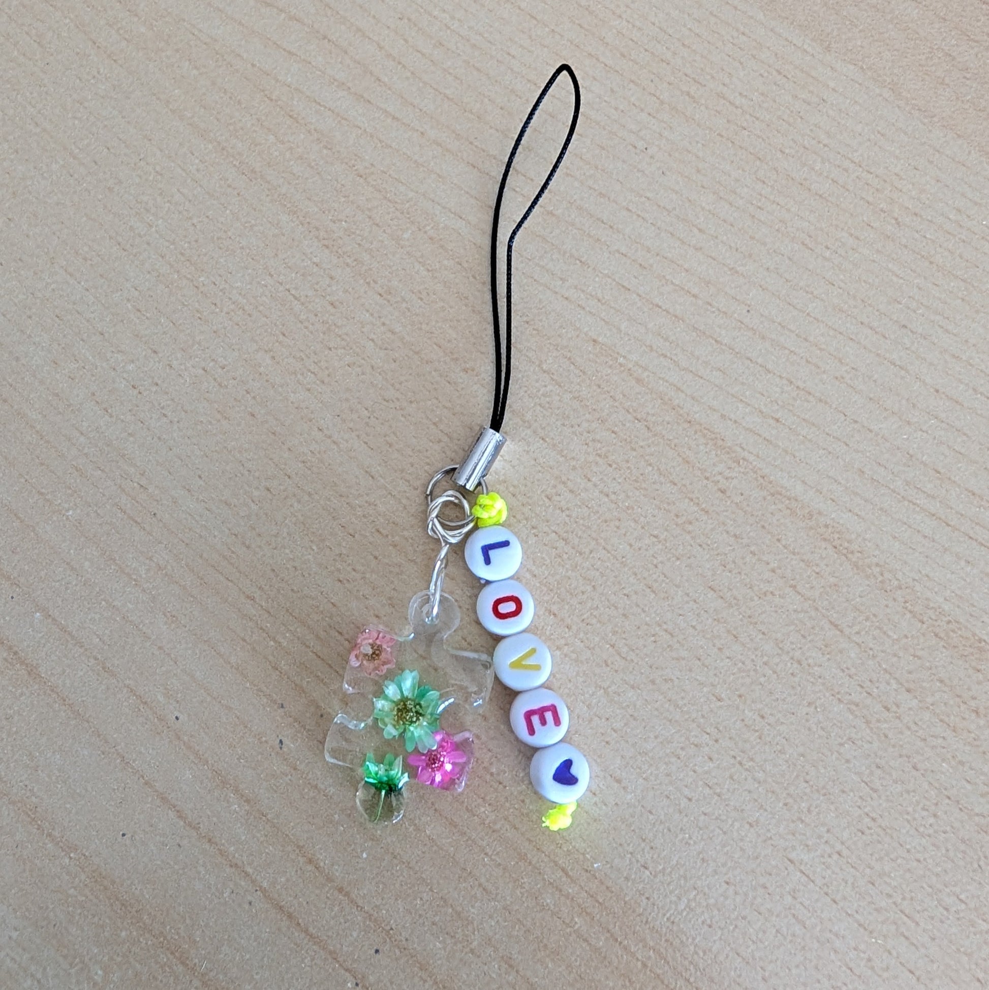 Spice up your phone with this charming resin charm, adorned with real dried flowers and beads. The 3.75 inch length adds a touch of flair to any device. (It's like a bouquet, but for your phone!)

Phone charm - Resin charm with dried flowers and beads