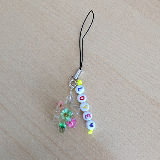 Spice up your phone with this charming resin charm, adorned with real dried flowers and beads. The 3.75 inch length adds a touch of flair to any device. (It's like a bouquet, but for your phone!)

Phone charm - Resin charm with dried flowers and beads